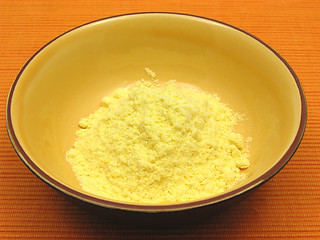 Image showing Cornmeal  in a bowl of ceramic on an orange background