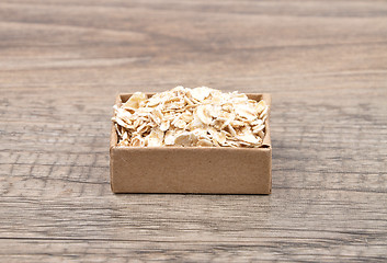 Image showing Oat flakes on wood