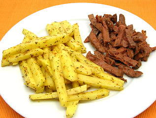 Image showing Soy Geschnetzeltes and french fries on white plate