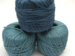 Image showing Three stapled  blue wool balls for needlework