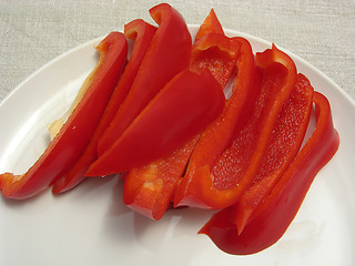 Image showing Slitted red pepper on a white plate and placemat