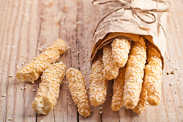 Image showing bread sticks grissini with sesame seeds in craft pack