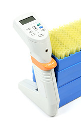 Image showing Electronic pipettor and tray of pipet tips