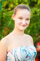 Image showing Portrait of face young beautiful girl woman on green outdoor bac