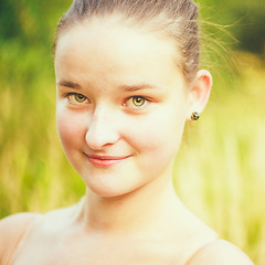 Image showing Portrait of face young beautiful girl woman on green outdoor bac