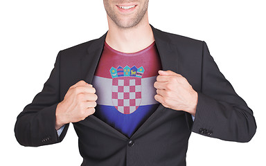 Image showing Businessman opening suit to reveal shirt with flag