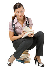 Image showing woman reading sitting on a pile of books