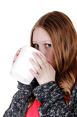 Image showing Girl drinking from big mug.