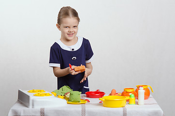 Image showing Little girl preparing food in the pan