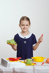 Image showing Girl cuts cabbage soup