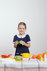 Image showing Five-year hostess with cabbage leaves