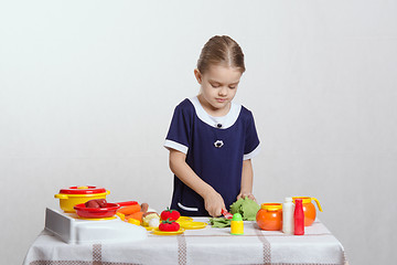 Image showing Girl in the kitchen preparing dinner