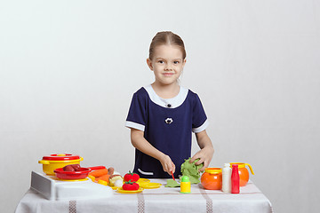 Image showing Little girl preparing food in the kitchen
