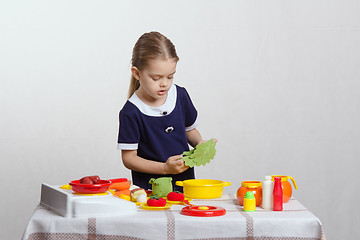 Image showing Girl enthusiastically prepares soup
