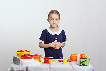 Image showing Girl on a toy kitchen