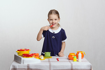 Image showing Five-year hostess tries dish taste