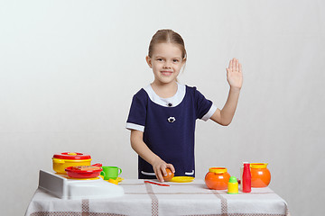 Image showing Girl in the kitchen waving goodbye