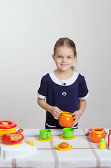 Image showing Girl with the children's kitchen utensils