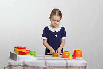 Image showing Girl cuts delicious pie