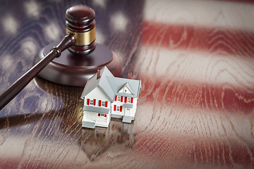 Image showing Small House and Gavel on Table with American Flag Reflection