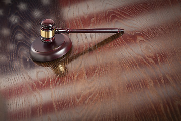 Image showing Wooden Gavel Resting on Flag Reflecting Table