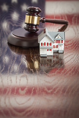 Image showing Small House and Gavel on Table with American Flag Reflection