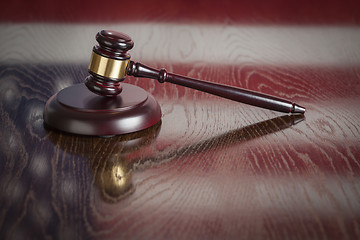 Image showing Wooden Gavel Resting on Flag Reflecting Table