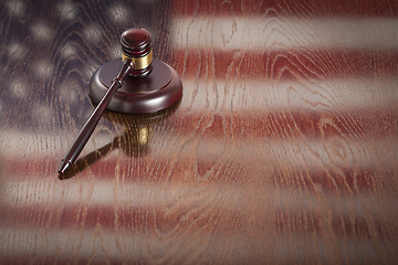 Image showing Wooden Gavel Resting on Flag Reflecting Table