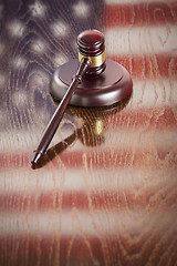 Image showing Wooden Gavel Resting on Flag Reflecting Table
