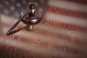 Image showing Wooden Gavel Resting on Flag Reflecting Table