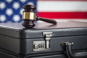 Image showing Briefcase and Gavel Resting on Table with American Flag Behind