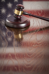 Image showing Wooden Gavel Resting on Flag Reflecting Table