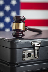 Image showing Briefcase and Gavel Resting on Table with American Flag Behind