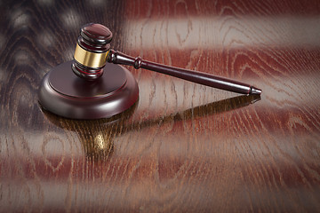 Image showing Wooden Gavel Resting on Flag Reflecting Table