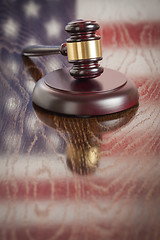 Image showing Wooden Gavel Resting on Flag Reflecting Table