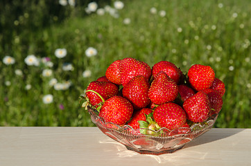 Image showing Fresh strawberries on a table  in garden