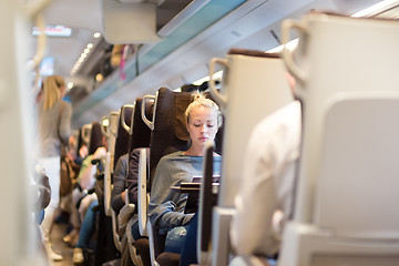 Image showing Lady traveling by train.