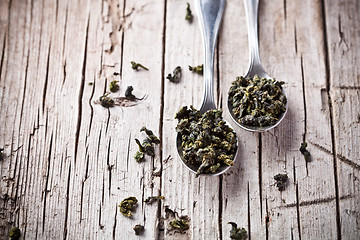 Image showing two spoons of dried green tea leaves