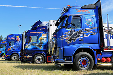 Image showing Row of Heavy Trucks with Artwork in a Show