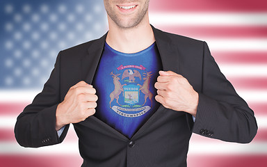 Image showing Businessman opening suit to reveal shirt with state flag