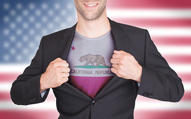 Image showing Businessman opening suit to reveal shirt with state flag