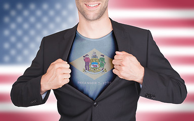 Image showing Businessman opening suit to reveal shirt with state flag