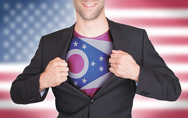 Image showing Businessman opening suit to reveal shirt with state flag