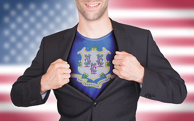 Image showing Businessman opening suit to reveal shirt with state flag