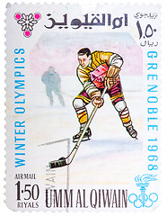 Image showing Stamp printed by Umm al-Quwain, shows hockey player bats the puc