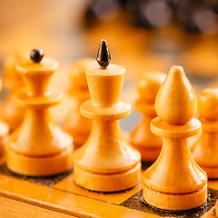 Image showing Ancient wooden chess standing on chessboard