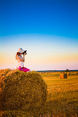 Image showing Beautiful Young Girl Woman In Dress Sitting On Haystack