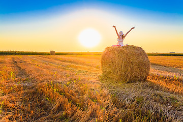 Image showing Beautiful Young Girl Sitting On Haystack