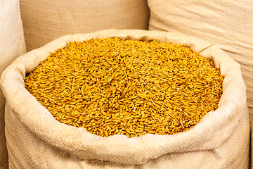 Image showing Bag Of Burlap Filled With Yellow Cereal Grain