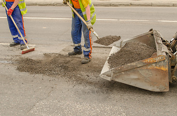 Image showing worker operating asphalt during road works 